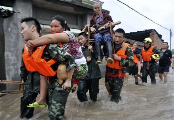 Rescue workers evacuate residents from flooded areas in Jianong town in Leshan in southwest China's Sichuan province on Sunday, July 18, 2010. Flooding and landslides in communities along the Yangtze River and other scattered parts of China have killed more than 130 people so far this month. (AP Photo)**CHINA OUT**